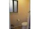 Small bathroom with a toilet, light fixture and a window at 1819 E Sheena Dr, Phoenix, AZ 85022