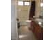 Bathroom with a tub, toilet and a sink with wooden cabinets and a tiled floor at 1819 E Sheena Dr, Phoenix, AZ 85022