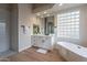 Bright bathroom featuring a shower, modern vanity and fixtures at 19608 N Regents Park Dr, Surprise, AZ 85387