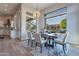 Elegant dining room featuring stylish decor, a modern chandelier, and large windows with outdoor views at 19608 N Regents Park Dr, Surprise, AZ 85387