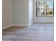 Empty hallway with light-colored hardwood floors and bright natural light at 19608 N Regents Park Dr, Surprise, AZ 85387