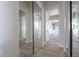 Hallway featuring full-length mirrored closet doors leading to the main bathroom at 19608 N Regents Park Dr, Surprise, AZ 85387