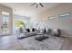 Bright living area featuring modern furnishings, a decorative rug, and abundant natural light at 19608 N Regents Park Dr, Surprise, AZ 85387