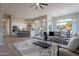 Bright, open-concept living room featuring modern decor, hardwood floors, and natural light at 19608 N Regents Park Dr, Surprise, AZ 85387