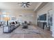 Bright living room featuring modern furnishings, stylish decor, and a ceiling fan at 19608 N Regents Park Dr, Surprise, AZ 85387