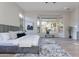 Bright primary bedroom boasts a modern bed, large window, and cozy decor at 19608 N Regents Park Dr, Surprise, AZ 85387