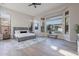 Spacious primary bedroom with luxury bed, large windows, and modern decor at 19608 N Regents Park Dr, Surprise, AZ 85387