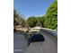 An outdoor grill sits atop a stone counter with a rock garden and hedges behind it at 19608 N Regents Park Dr, Surprise, AZ 85387