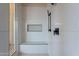 Modern shower featuring sleek tile, a built-in bench, and updated fixtures at 19608 N Regents Park Dr, Surprise, AZ 85387