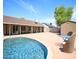 Backyard featuring pool, lounge chairs, brick patio, storage shed, and mature trees at 20609 N 4Th Ave, Phoenix, AZ 85027