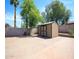 Backyard featuring a storage shed and brick-paved patio area, bordered by a block wall and landscaping at 20609 N 4Th Ave, Phoenix, AZ 85027