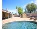 Inviting backyard featuring pool, brick patio, storage shed, and mature trees at 20609 N 4Th Ave, Phoenix, AZ 85027