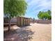 Backyard featuring storage shed, brick patio, landscaping, a pool, and a seating area under a blue sky at 20609 N 4Th Ave, Phoenix, AZ 85027