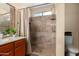 Bathroom features a tiled shower with glass door, vanity with storage, and updated fixtures at 20609 N 4Th Ave, Phoenix, AZ 85027
