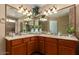 Dual sink vanity with stone counter, framed mirror, and decorative lighting in the spacious bathroom at 20609 N 4Th Ave, Phoenix, AZ 85027