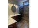 Bathroom featuring dual sinks, stone countertop, decorative mirror, and tiled walk-in shower at 20609 N 4Th Ave, Phoenix, AZ 85027