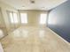 Bright bedroom with neutral walls, tile flooring, mirrored closet doors, and a blue accent wall at 20609 N 4Th Ave, Phoenix, AZ 85027