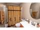 Well-lit bathroom showcasing a unique shower curtain, a decorative mirror, and a sink with stylish fixtures at 2101 S Meridian Rd # 176, Apache Junction, AZ 85120