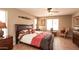 Comfortable bedroom with a ceiling fan, natural lighting, and tile flooring at 2101 S Meridian Rd # 176, Apache Junction, AZ 85120