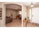 Inviting entryway with an arched doorway, a console table, and views into an adjacent room with a desk at 2101 S Meridian Rd # 176, Apache Junction, AZ 85120