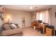 Comfortable home office with a cozy couch, a wooden desk, and a window with stylish curtains at 2101 S Meridian Rd # 176, Apache Junction, AZ 85120