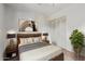 Cozy bedroom featuring a wood frame bed, stylish lamps, and a modern art piece at 2145 W Cholla St, Phoenix, AZ 85029