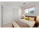 Inviting bedroom featuring a wooden bed frame, and a bright window view at 2145 W Cholla St, Phoenix, AZ 85029