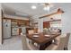 Spacious kitchen with wood cabinets, a dining table for six, and an open layout connecting to a cozy living area at 2145 W Cholla St, Phoenix, AZ 85029