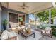 Relaxing covered patio with comfortable seating, ceiling fan, and views of the backyard at 2145 W Cholla St, Phoenix, AZ 85029