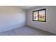 Cozy bedroom with plush carpeting and a window offering views of a well-maintained neighborhood at 2440 N 22Nd Ave, Phoenix, AZ 85009