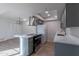 Modern kitchen with stainless steel appliances, gray cabinetry, and an island with a cooktop at 2440 N 22Nd Ave, Phoenix, AZ 85009