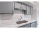 Updated kitchen with stainless steel sink, modern fixtures, and beautiful countertops and gray cabinets at 2440 N 22Nd Ave, Phoenix, AZ 85009