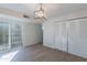 Well-lit living area with updated flooring, a sliding glass door, and a large closet at 2440 N 22Nd Ave, Phoenix, AZ 85009