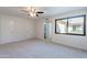 Spacious bedroom featuring neutral tones, a ceiling fan, and a bright window at 2440 N 22Nd Ave, Phoenix, AZ 85009
