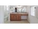 Well-lit bathroom with granite vanity, large mirror, neutral tile, and toilet visible at 27380 N 128Th Ln, Peoria, AZ 85383