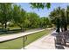 Two well-maintained bocce ball courts surrounded by lush greenery and seating areas at 27380 N 128Th Ln, Peoria, AZ 85383
