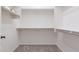 Walk-in closet with neutral carpet and shelving, offering storage at 27380 N 128Th Ln, Peoria, AZ 85383