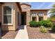 Close up of a beige house with stone accents, desert landscaping, and manicured bushes at 27380 N 128Th Ln, Peoria, AZ 85383