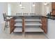 Kitchen island with storage cabinets and drawers with bar stool seating at 27380 N 128Th Ln, Peoria, AZ 85383