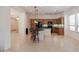 Spacious, open-plan kitchen with island seating and tile flooring at 27380 N 128Th Ln, Peoria, AZ 85383