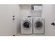 Functional laundry room equipped with a modern washer and dryer at 27380 N 128Th Ln, Peoria, AZ 85383