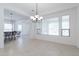 Open living space with tile floors, neutral walls, and decorative ceiling lights at 27380 N 128Th Ln, Peoria, AZ 85383