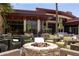 Elegant outdoor patio with comfortable seating, a fire pit, and views of the surrounding landscape at 27380 N 128Th Ln, Peoria, AZ 85383
