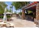 Picturesque outdoor seating area with shaded tables, stone accents and manicured landscaping at 27380 N 128Th Ln, Peoria, AZ 85383
