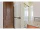 Walk-in shower with glass door and tile surround with integrated seat at 27380 N 128Th Ln, Peoria, AZ 85383