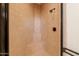 Close-up of shower stall featuring tile surround with integrated seat at 27380 N 128Th Ln, Peoria, AZ 85383