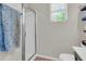 Bright bathroom featuring a glass enclosed shower and modern fixtures and shelves at 3029 E Patrick St, Gilbert, AZ 85295