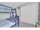 Cozy bedroom featuring bunk beds, neutral gray walls, and white closet doors at 3029 E Patrick St, Gilbert, AZ 85295
