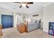 Spacious bedroom with a ceiling fan, blue armoire, and ample natural light at 3029 E Patrick St, Gilbert, AZ 85295