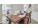 Dining room with a wooden table set for dinner; kitchen view at 3029 E Patrick St, Gilbert, AZ 85295
